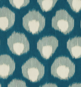 Close-up of a textile with an abstract ikat pattern featuring irregular white-centered shapes surrounded by soft blue and dark teal outlines on a darker teal background.