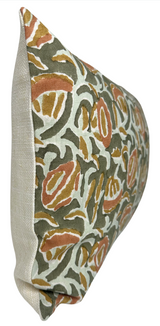 Rectangular pillow with multicolor abstract floral pattern in green, rust, and mustard on front, and solid beige fabric on the side panel, shown at an angle.