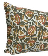 Rectangular pillow cover with an abstract pattern in olive green, rust, mustard, and white on a textured fabric background.