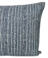 Close-up of a Saqqara woven pillow cover in Pacific Blue featuring vertical dark blue and white textured stripes with a subtle, intricate pattern.