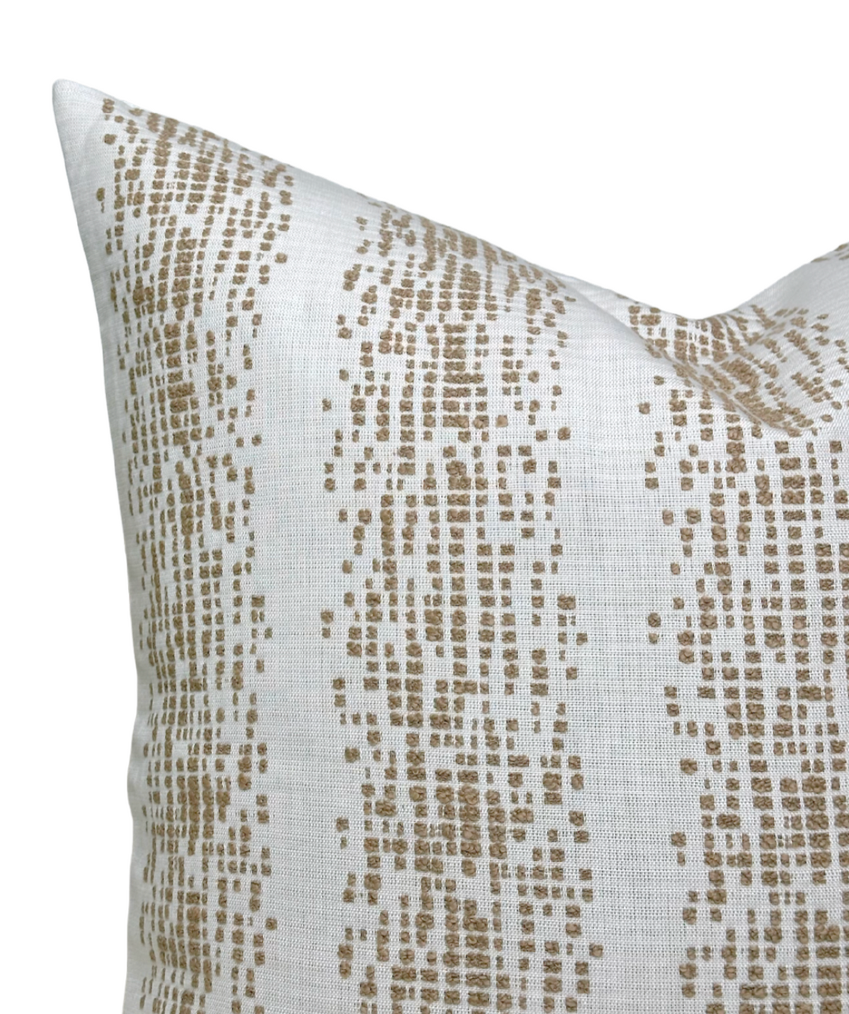 Close-up of a white pillow cover featuring an irregular vertical pattern of small fawn brown rectangles and squares forming organic stripes.
