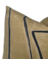 Close-up of a Graffito Pillow Cover in Java, featuring a tan fabric with bold, irregular black line patterns forming geometric shapes.