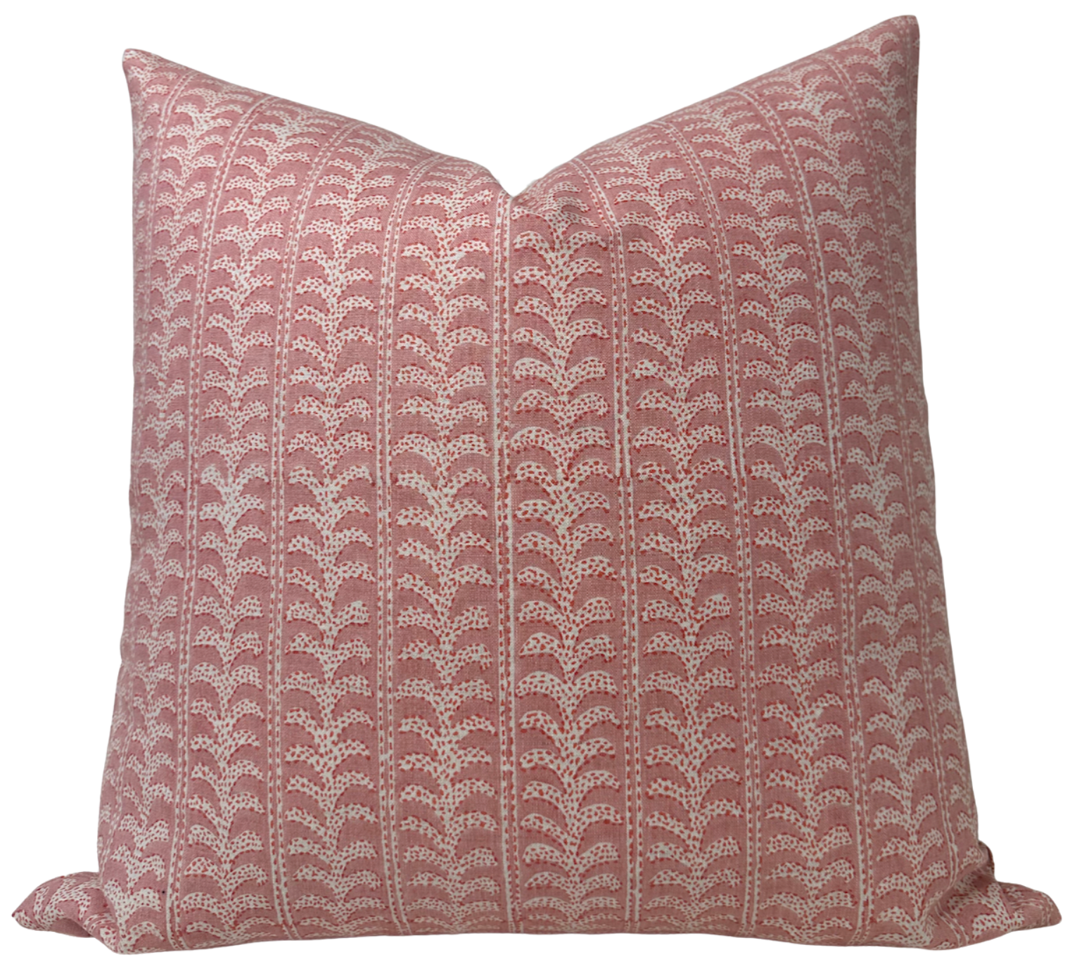 Luxor Pillow Cover in Guava displayed on an armchair with complementary cushions