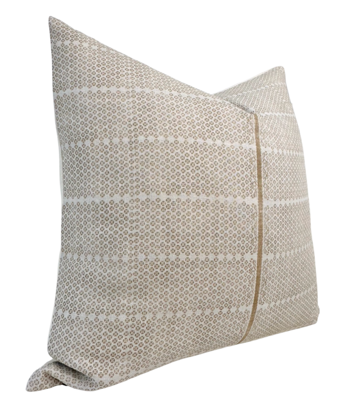 Square pillow cover in sand brown with horizontal stripes of small repeated geometric motifs in white, showing a slight fold at the bottom corner.