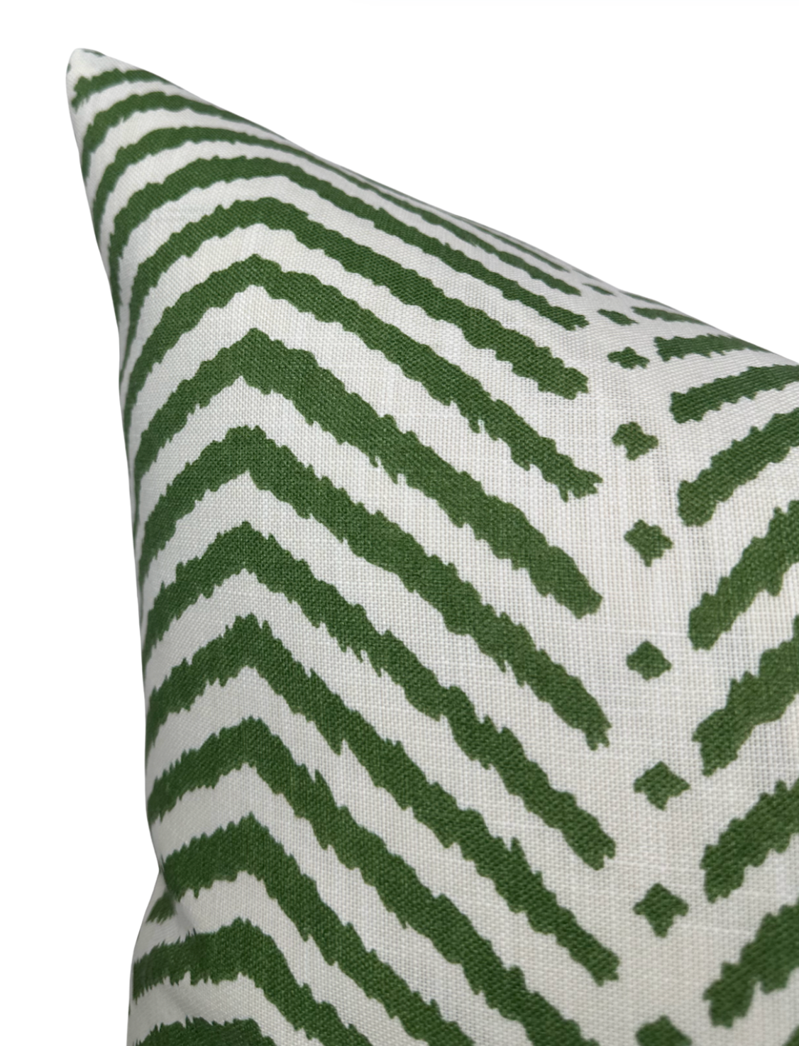 Close-up of La Jolla pillow cover with a white background and bold, irregular zigzag stripes in verde green creating a dynamic pattern.