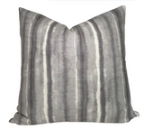 Charcoal striped Kumo Stripe Pillow Cover with ivory linen back on a white couch