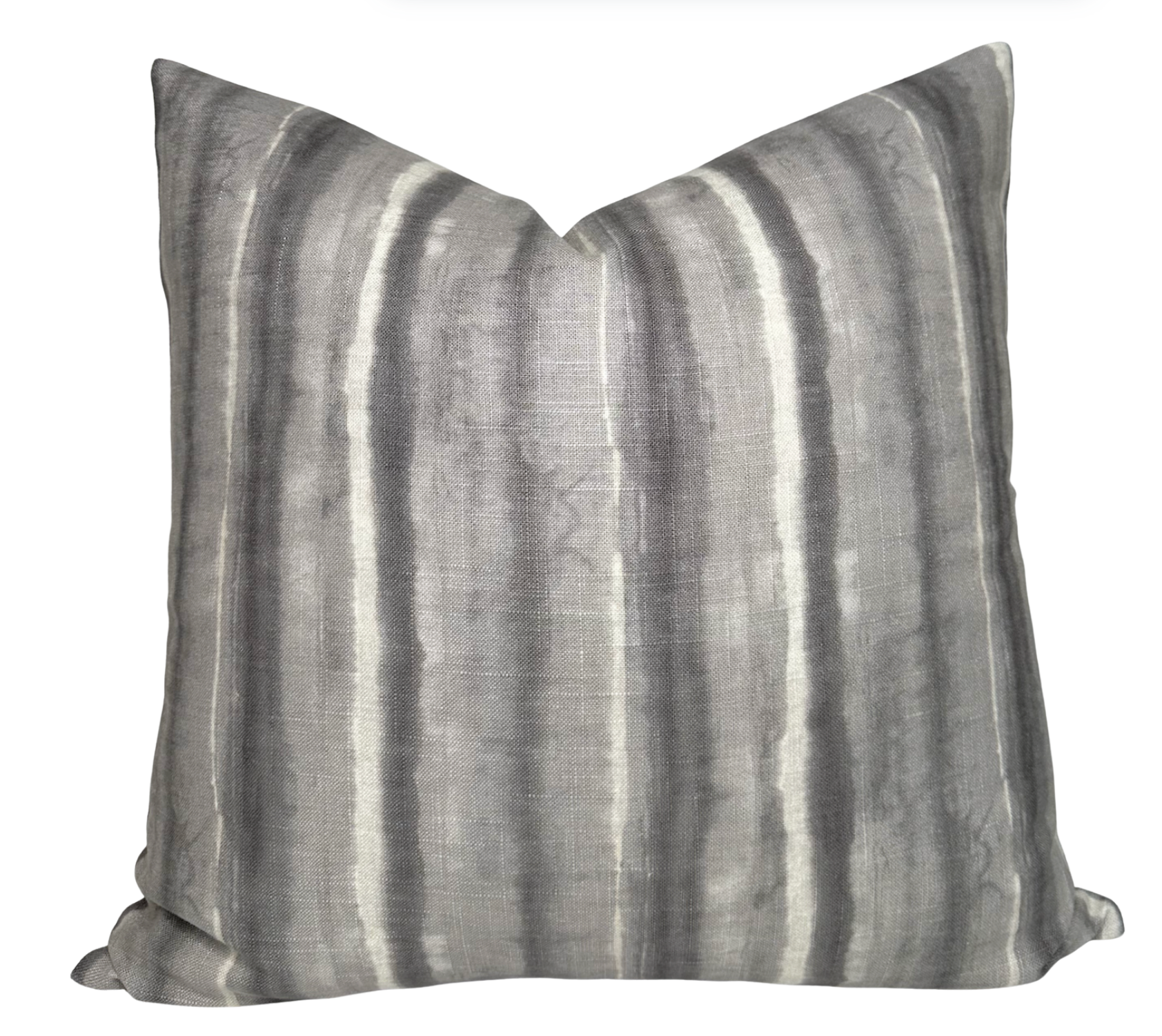Charcoal striped Kumo Stripe Pillow Cover with ivory linen back on a white couch