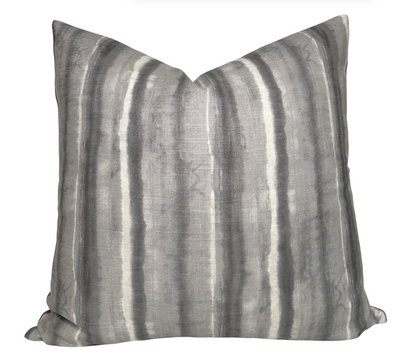 Charcoal striped Kumo Stripe Pillow Cover with ivory linen back on a white couch