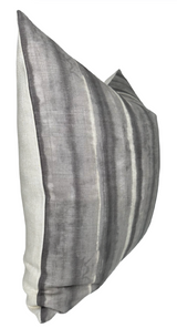Rectangular pillow cover with charcoal and gray vertical stripes in a subtle watercolor effect on a light ivory background, shown slightly angled.