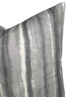 Close-up of a rectangular pillow cover with charcoal gray and light gray vertical stripes in a soft, textured fabric.