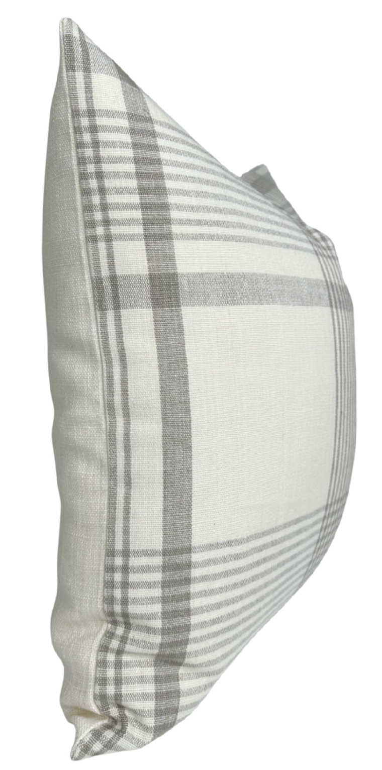 Square pillow with beige and light gray plaid pattern on a soft fabric, shown at a slight angle highlighting its plump shape and clean edges.