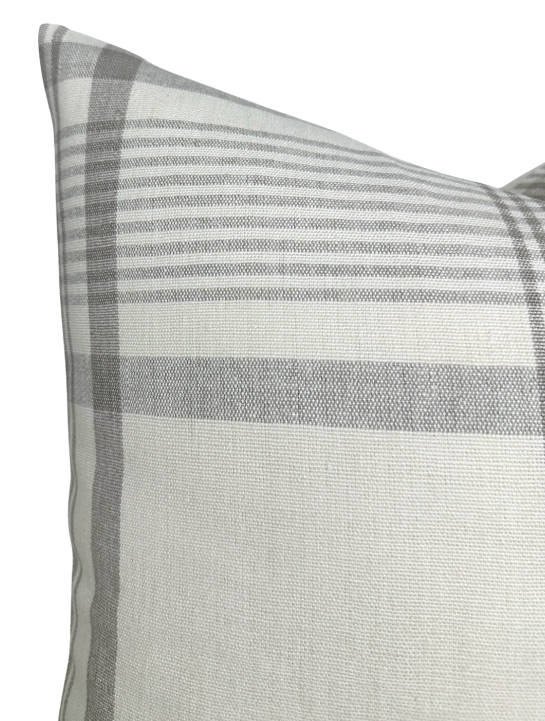 Close-up of a beige pillow cover featuring a subtle plaid pattern in various shades of gray, highlighting the fabric's texture and stitched edges.