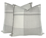 Pair of beige and gray plaid patterned square pillow covers with a soft fabric texture, shown against a white background.
