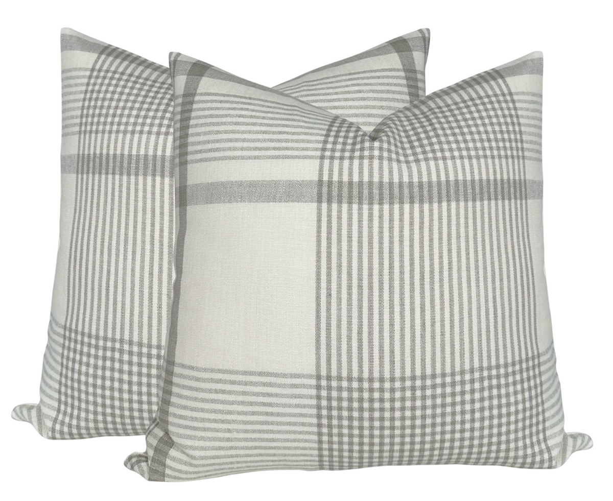 Pair of beige and gray plaid patterned square pillow covers with a soft fabric texture, shown against a white background.