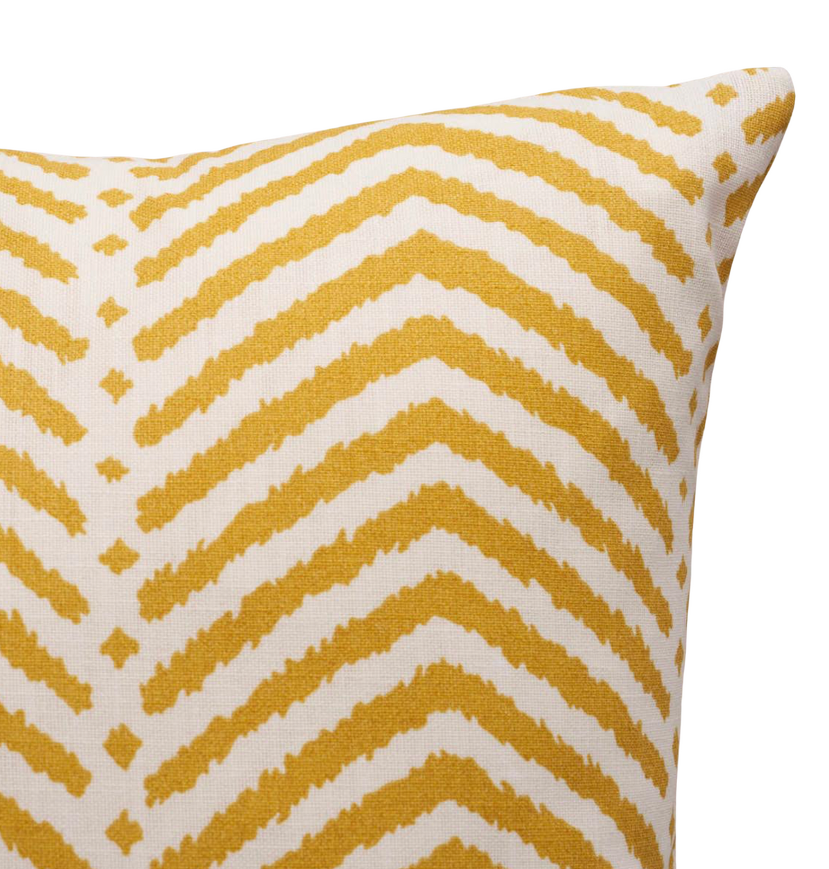 Corner view of a pillow cover with marigold yellow chevron stripes on a white background, showing textured fabric and sharp edges.