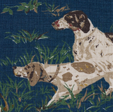 Navy blue fabric featuring a detailed illustration of two brown and white pointers poised in tall green grass, with scattered small flowers and leaves.