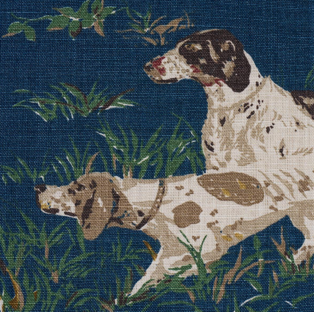 Navy blue fabric featuring a detailed illustration of two brown and white pointers poised in tall green grass, with scattered small flowers and leaves.