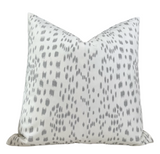 Les Touches Pillow Cover in Gray styled on a sofa