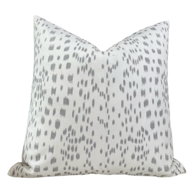 Les Touches Pillow Cover in Gray styled on a sofa