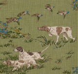 Green fabric patterned with brown-and-white pointer dogs and flying ducks amidst grass and small blue and yellow flowers.