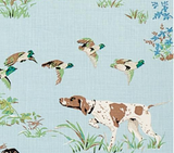 Illustration of a brown and white pointer dog in a grassy field with flying mallard ducks against a sky blue background.