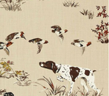 Brown and white hunting dog with wings of flying birds above on beige background with scattered grass and fall foliage in brown and red hues.