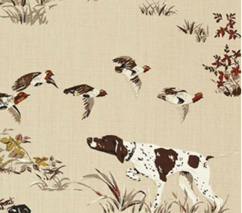 Brown and white hunting dog with wings of flying birds above on beige background with scattered grass and fall foliage in brown and red hues.
