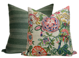 Two square pillows, one with beige background featuring multicolored floral and leaf patterns, the other with textured green horizontal stripes, shown side by side.