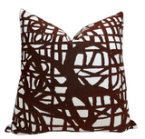 Ecriture Pillow Cover in Rust shown on seating with textured woven fabric and coordinating ivory back