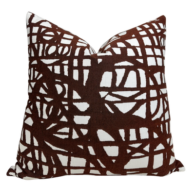 Ecriture Pillow Cover in Rust shown on seating with textured woven fabric and coordinating ivory back