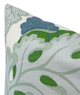 White fabric pillow cover featuring stylized green leaves and a detailed blue and green parakeet motif in a soft, naturalistic pattern.