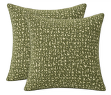 Pair of square pillow covers in chive green with textured, irregular pixelated pattern on a beige background.