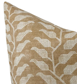 Ochre-colored pillow cover featuring a white geometric leaf pattern with a textured woven fabric surface, shown at a close angled view.
