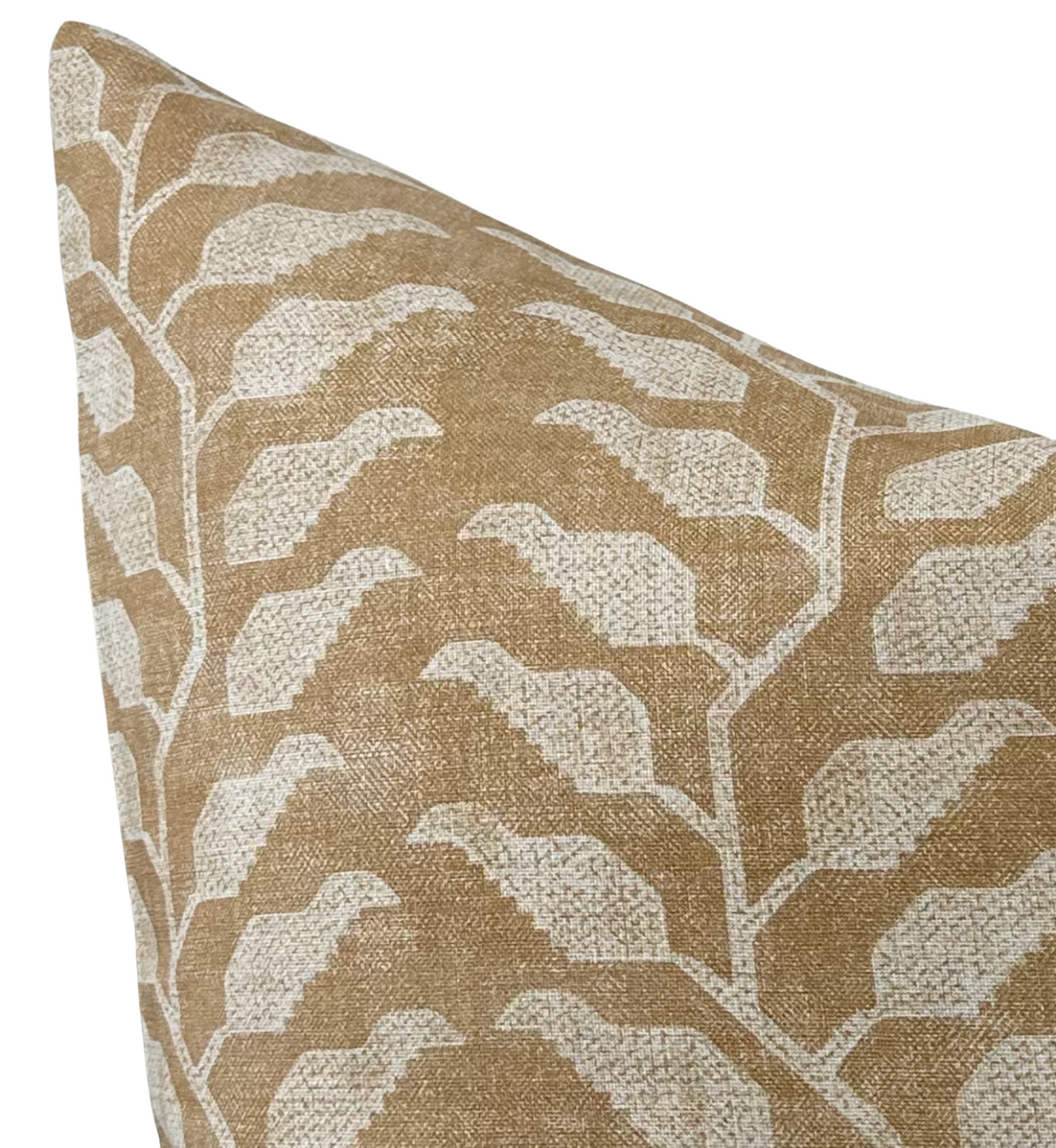 Ochre-colored pillow cover featuring a white geometric leaf pattern with a textured woven fabric surface, shown at a close angled view.
