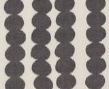 Vertical columns of faded black circle shapes on an off-white background, creating a textured, patterned fabric from Schumacher Textiles.