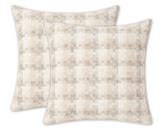 Two square pillow covers featuring a subtle woven check pattern in soft natural beige and cream tones with piped edges, arranged slightly overlapping on a white background.