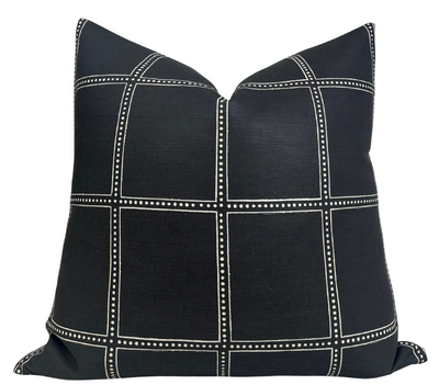 Black Postage Pillow Cover by DEKOWE, styled on a cream sofa
