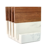 Set of four rectangular coasters with a two-tone design, featuring warm brown wood on the top half and smooth white marble with subtle gray veining on the bottom, held in a matching marble holder.