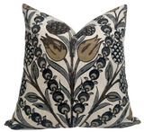 Square pillow with an intricate botanical pattern featuring gold and grey tulip-like flowers and leaves on a light background.