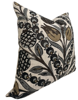 Cornelia Pillow Cover featuring large botanical motifs in muted gold, black, and grey on a beige background, angled to show texture and depth.