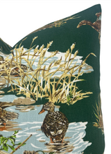Green pillow cover featuring a vintage-style illustration of ducks wading in water surrounded by tan reeds and pale blue reflections