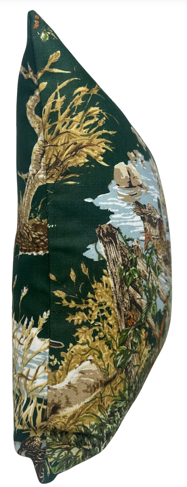 Side view of a pillow cover with dark green background featuring detailed naturalistic prints of trees, branches, and water in earthy brown, beige, and blue tones.