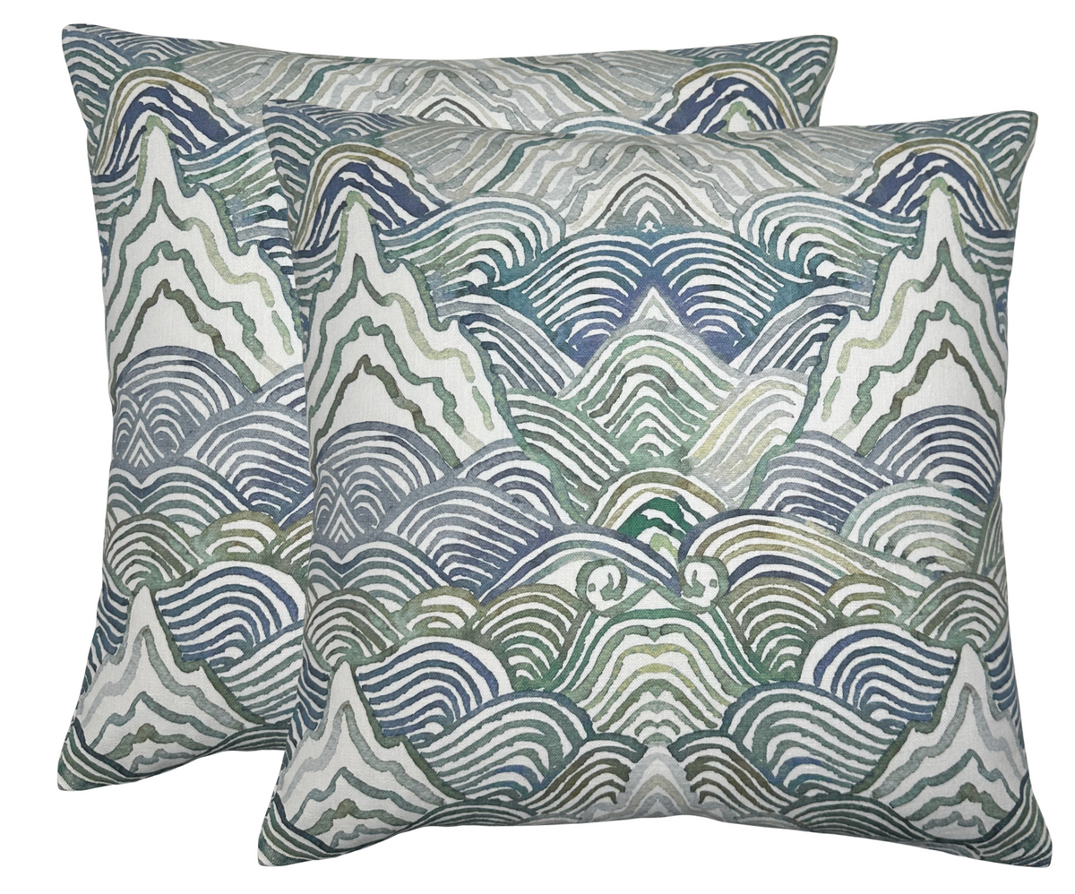 Pair of square pillow covers with abstract mountain and wave patterns in shades of green, blue, and gray on a white background.