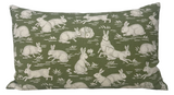 Rectangular sage green pillow cover patterned with various white cottontail rabbits in different poses and small grass tuft accents, finely detailed in dotted style.