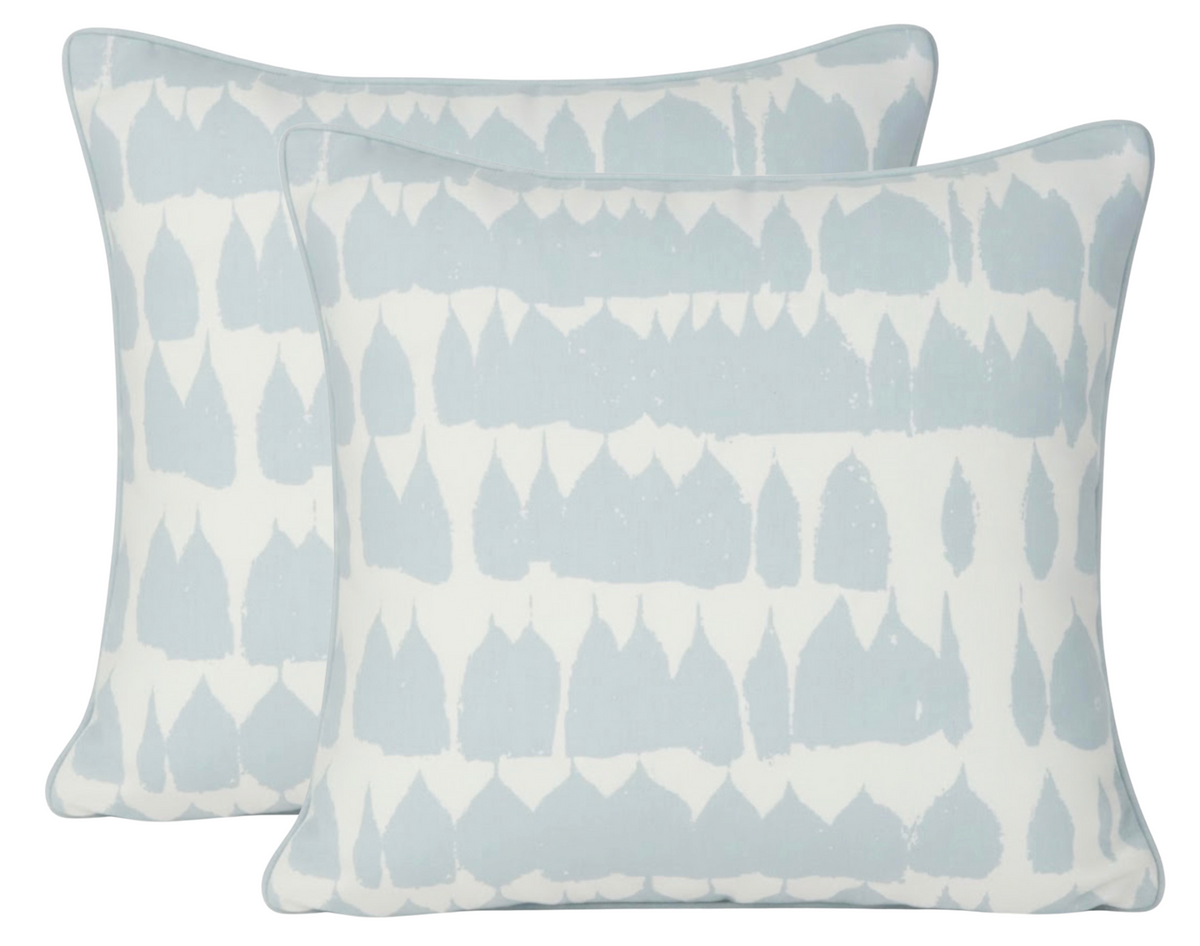 Two rectangular pillows with sky blue and white abstract leaf-like pattern and piped edges, arranged to show front and back sides.