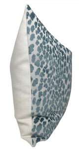Rectangular pillow cover featuring marine blue velvet spots on a light fabric front and solid cream-colored fabric on the back and sides.