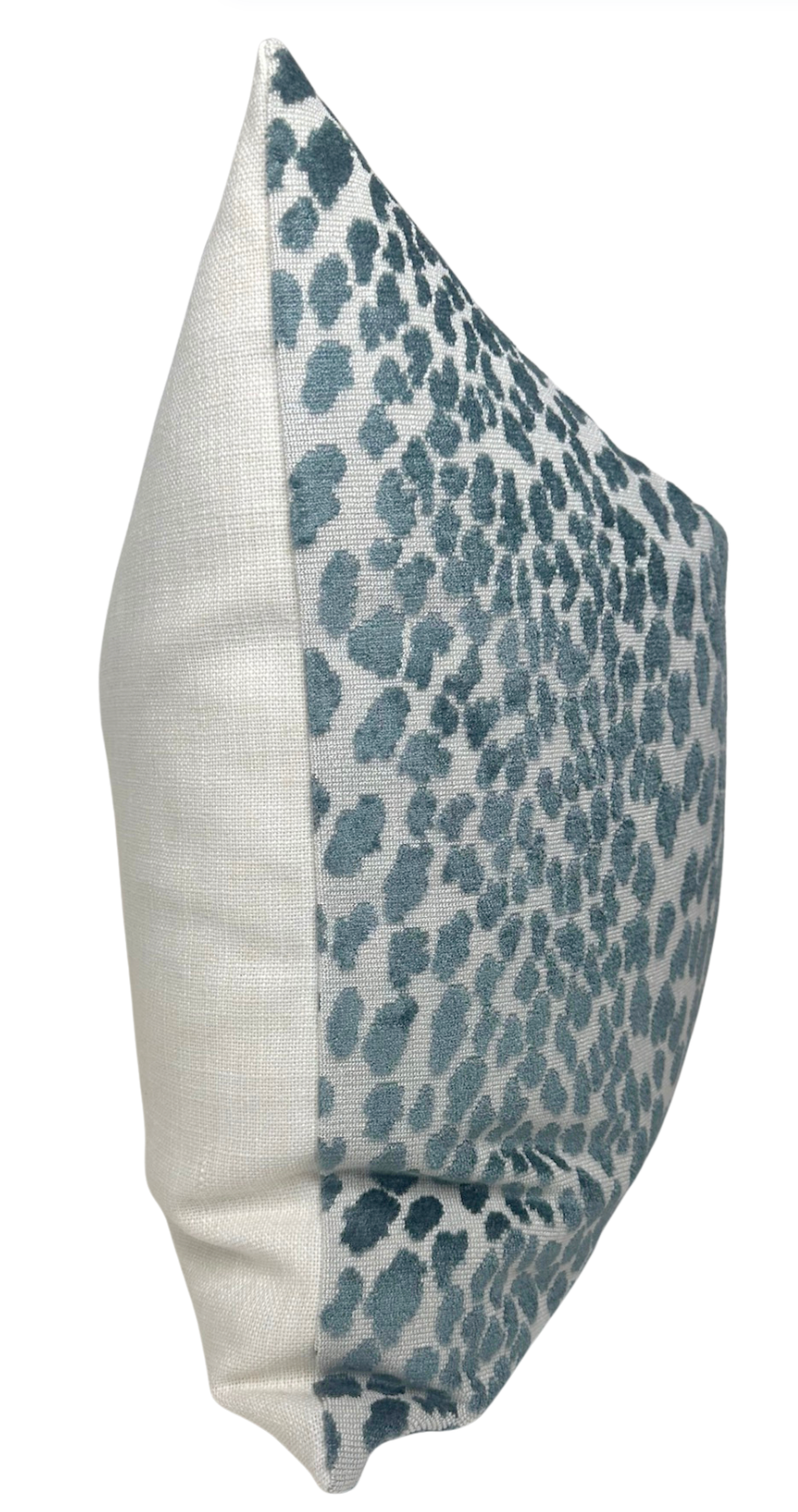 Rectangular pillow cover featuring marine blue velvet spots on a light fabric front and solid cream-colored fabric on the back and sides.