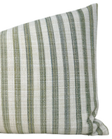 Close-up of a pillow cover with vertical green and white stripes of varying widths, showing a textured woven fabric.