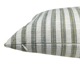 Close-up of a pillow corner showing tightly woven fabric with vertical stripes in varying shades of green, gray, and beige with a visible white zipper on the side.