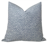 Indigo blue Sarong Weave Pillow Cover with ivory backing displayed on a chair